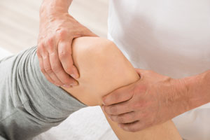 Physical Therapist examining a knee