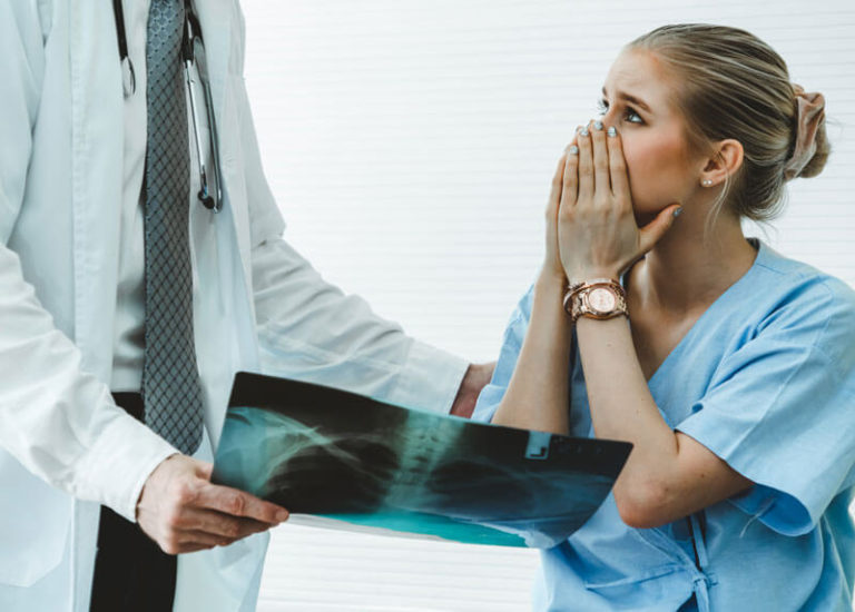 oncologist showing x-ray to patient