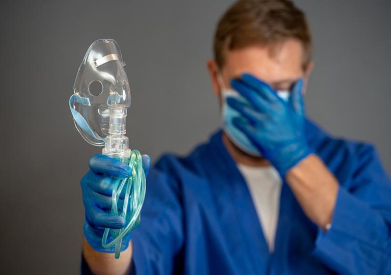 embarrassed doctor holding CPAP breathing ventilator