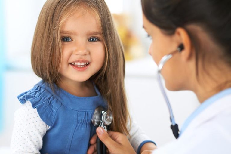 female child being seen by pediatrician